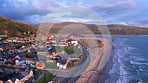 Aerial view over coastal town at stormy sunset