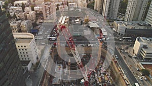 Aerial view over construction site at daytime. workers, engineers, cranes and concrete cement on site. big