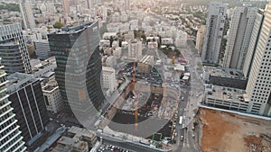 Aerial view over construction site at daytime. workers, engineers, cranes and concrete cement on site. big