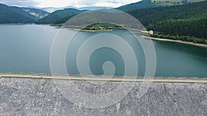 Aerial view over the dam of Bolboci lake and Bucegi mountains, Romania