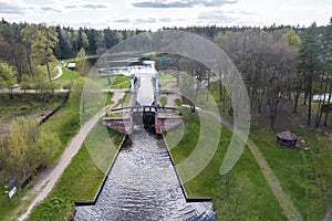 aerial view over dam lock sluice on lake impetuous waterfall photo