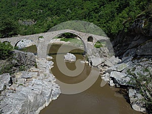 Aerial view over the Devil`s Bridge, an arch bridge over the Arda River in a narrow gorge, Bulgaria