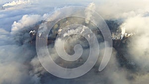 Aerial view over dirty smoke and smog from pipes of steel factory and blast furnaces. industrialized city, pollution