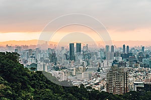 Aerial view over Downtown Taipei with layers of mountain in background in the dusk from Xiangshan Elephant Mountain in the evening