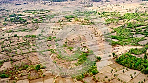 Aerial view over harvested rice plantations in Cambodia, landscape with empty rice fields.