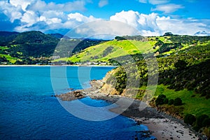 Aerial view over Hokianga Harbour surrounded by lush green hills and cozy beached. Iconic New Zealand, Northland