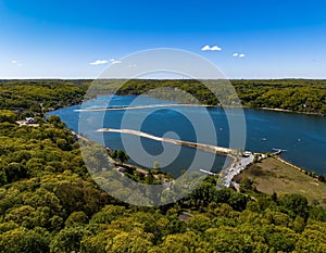 Aerial view over a large sandbar in the green waters of Oyster Bay in Lloyd Harbor on Long Island