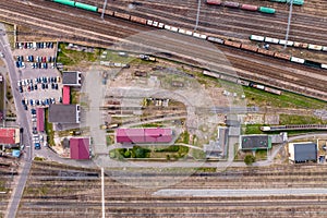 aerial view over long railway freight trains with lots of wagons stand on parking