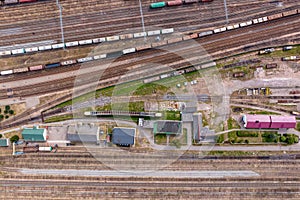 aerial view over long railway freight trains with lots of wagons stand on parking