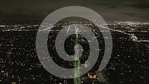 AERIAL: View over Los Angeles at Night with Wilshire Boulevard Glowing Streets and City Car Traffic Lights