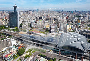 Aerial view over the modern & futuristic architecture of Taichung Train Station in downtown, with high rise towers standing among