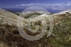 Aerial view over mountains to the rural road