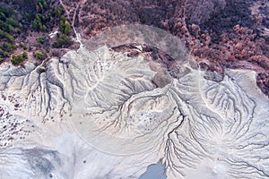 Aerial view over the muddy volcano Paclele Mici and Paclele Mari in Buzau county , natural park in Romania