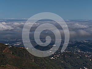 Aerial view over the northeast of island Gran Canaria, Canary Islands, Spain with city Las Palmas covered by a sea of clouds. photo