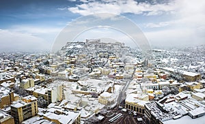 Aerial view over the old town of Athens with snow during winter time