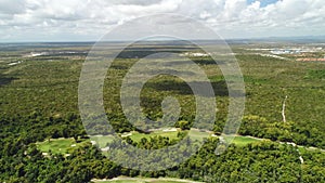 Aerial view over palm trees jungle and golf course in tropical caribbean resort