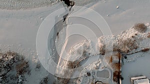 Aerial view over partially frozen sea and small river delta