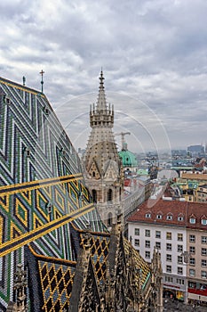 Aerial view over the rooftops of Vienna city from the north tower of St. Stephen`s Cathedral with the cathedral`s famous ornatel