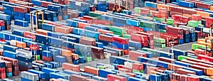 Aerial view over shipping containers stacked on a commercial port