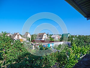 Aerial view over soviet era dacha country houses with small green gardens