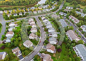 Aerial view over suburban homes and roads early sunrise