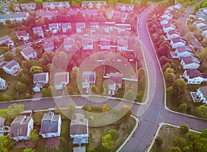 Aerial view over suburban homes and roads early sunrise