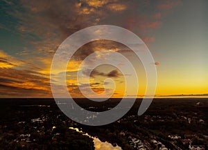 Aerial view over suburban homes and roads early sunrise