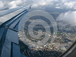 Aerial view over Thames river and London suburbs seen from airplane flying high above Bermondsey photo