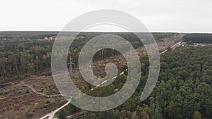 Aerial view over transmission power lines in forest. Power lines in the beautiful landscape of nature. Green energy sustainability