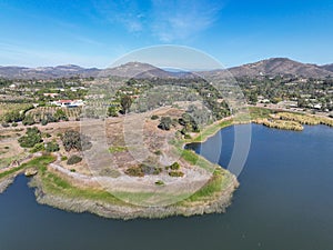 Aerial view over water reservoir and a large dam that holds water. Rancho Santa Fe in San Diego