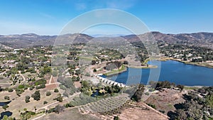 Aerial view over water reservoir and a large dam that holds water. Rancho Santa Fe in San Diego