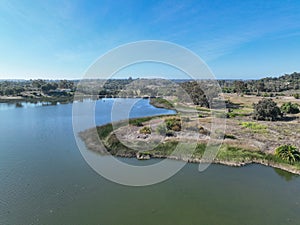 Aerial view over water reservoir and a large dam that holds water. Rancho Santa Fe in San Diego