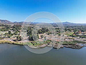 Aerial view over water reservoir and a large dam that holds water. Rancho Santa Fe in San Diego