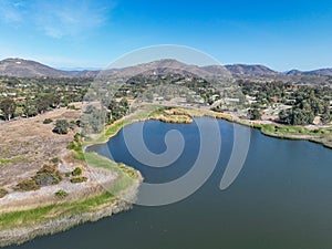 Aerial view over water reservoir and a large dam that holds water. Rancho Santa Fe in San Diego