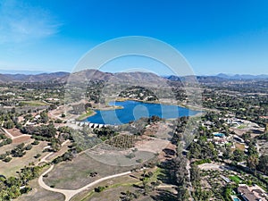 Aerial view over water reservoir and a large dam that holds water. Rancho Santa Fe in San Diego