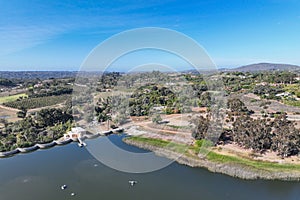 Aerial view over water reservoir and a large dam that holds water. Rancho Santa Fe in San Diego