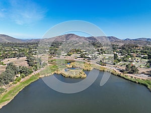 Aerial view over water reservoir and a large dam that holds water. Rancho Santa Fe in San Diego