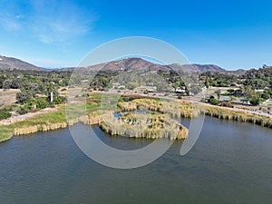 Aerial view over water reservoir and a large dam that holds water. Rancho Santa Fe in San Diego