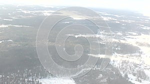 Aerial view over winter forest landscape with evergreen trees