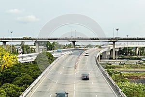 Aerial view of overpass superhighway in countryside of Thailand show light traffic on beautiful summer holiday season.Image use