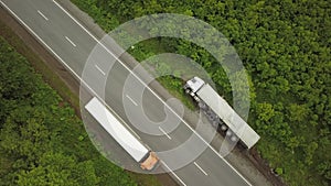 Aerial view of an overturned truck. Car on the side of the highway.