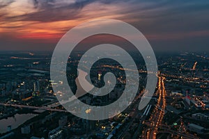 Aerial view panorama of night city Moscow, Russia. Urban cityscape after sunset with illuminated streets and building