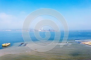 Aerial view of panoramic seaport warehouse and container ship, crane vessel working for delivery of delivery containers. Yuzhny