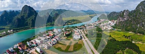 Aerial view: Panoramic view Phong Nha town and Son river in background of mountains in Quang Binh province, Vietnam