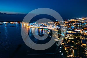 Aerial view of Paphos embankment or promenade at night with reflection of city lights in sea water. Famous Cyprus