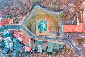 Aerial view parallel to the ground of St. Andrew`s Church and St. Andrew`s Descent in heavy fog, Kyiv, Ukraine