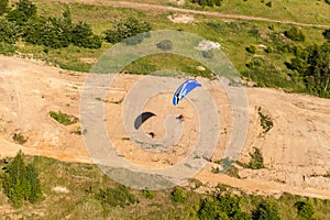 Aerial view of paramotor flying over the fields