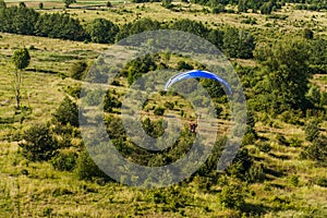 Aerial view of paramotor flying over the fields