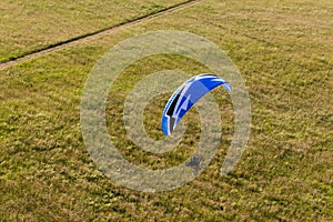 Aerial view of paramotor flying over the fields