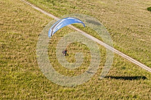 Aerial view of paramotor flying over the fields